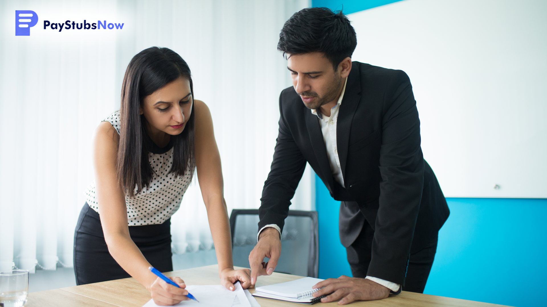 Two business people discussing documents