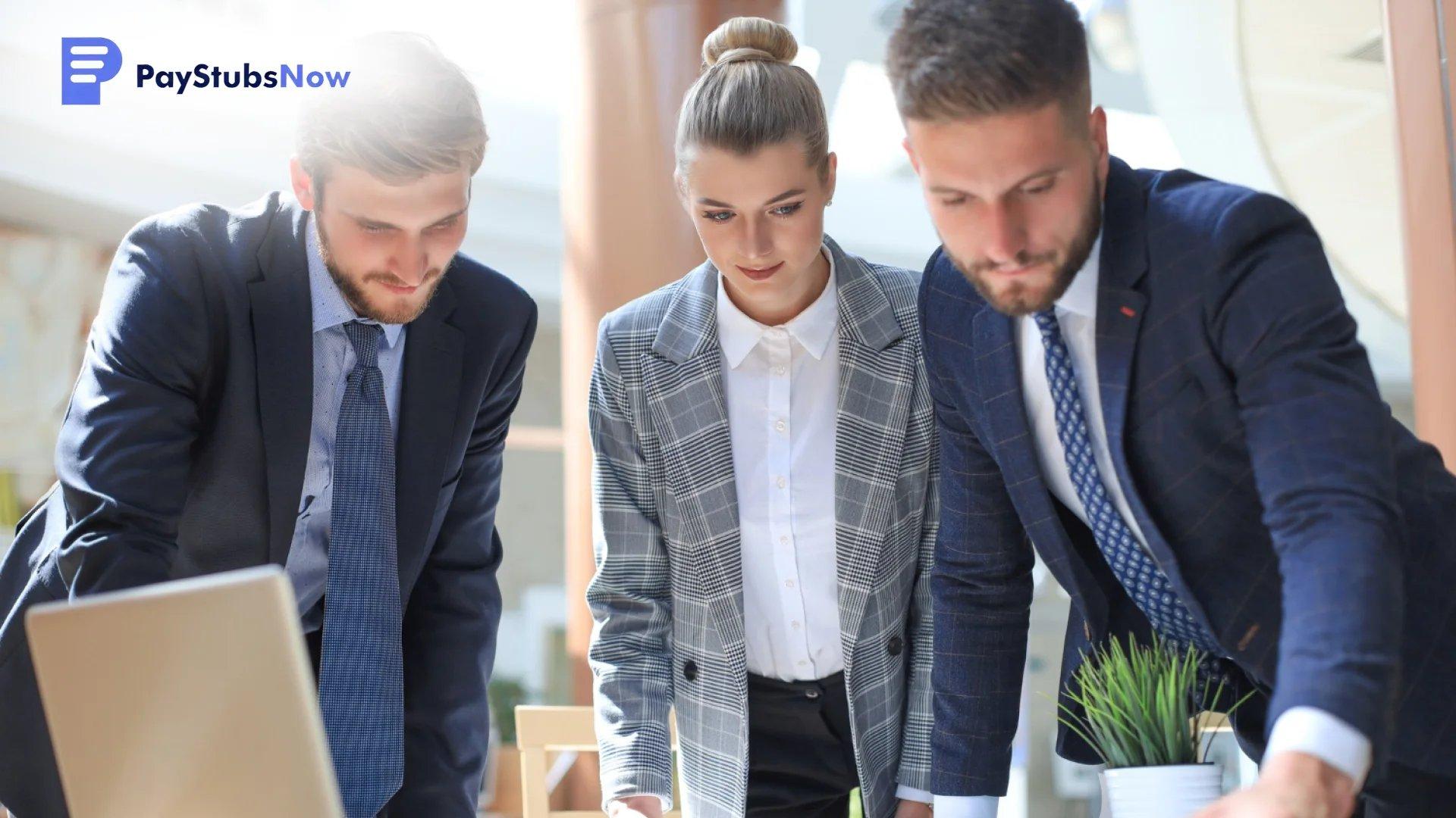 Three professionals in business attire looking closely at a laptop to discuss where to file and how to deliver.